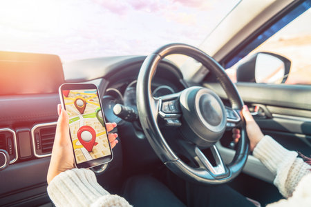 Female Driver Using Navigation Device in Car