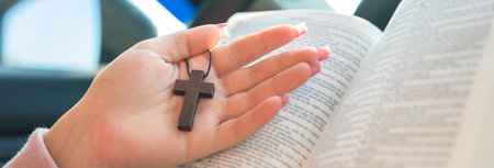 Woman in car holding Bible and cross, safe driving, God's protection