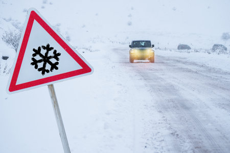 Warning sign: first snow, driving in fogの写真素材