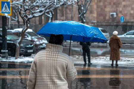 City Residents Walking Outside in Cold Winter Weatherの写真素材