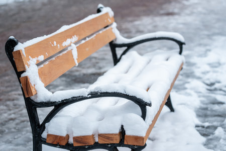 Wooden Benches Completely Covered in Snowの写真素材