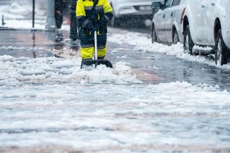Man Removing Snow from the Streetの写真素材