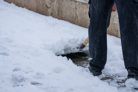 Man Removing Snow from the Streetの写真素材