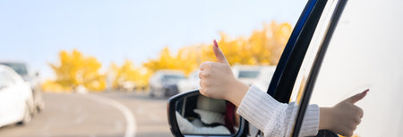 Positive Vibes on the Road: A Female Driver's Thumbs Up for Joyful Driving Experiences