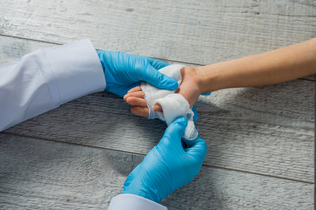 Doctor Bandaging a Child's Hand â Pediatric Healthcare and First Aidの写真素材