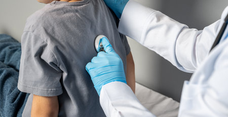 Doctor Checking Child's Breathing with Stethoscopeの写真素材