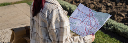 Navigating New Horizons: A Tourist Orients Himself with a Map in the Cityの写真素材