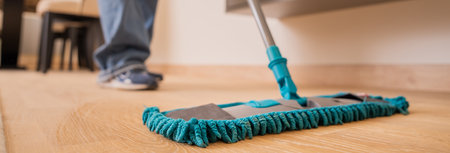 Sparkling Clean: A Woman Mops the Floorの写真素材