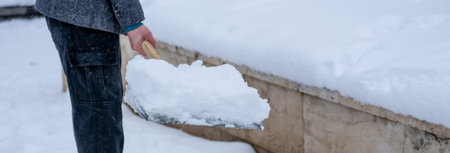 Man Removing Snow from the Streetの写真素材