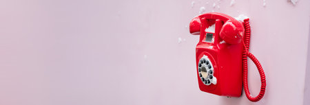 Old Red Telephone on the Wall, Covered in Snowの写真素材