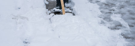 Man Removing Snow from the Streetの写真素材