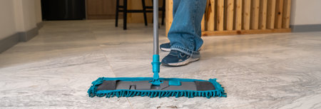 House cleaner mops the floor, cleanliness concept