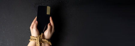 Smartphone Addiction: Hands Tied by Dependencyの写真素材