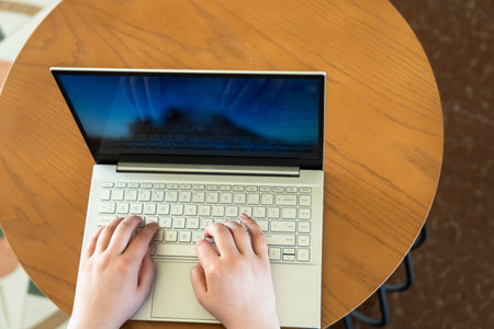 Business Professional Working on Laptop in CafÃ©