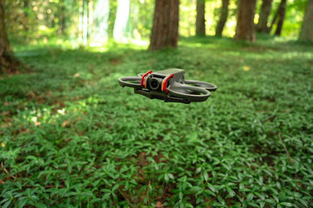 Drone flying above a dense forest, capturing aerial perspectives, exploring natural landscapes, and...