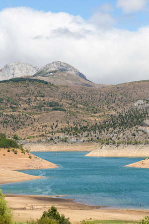 Lake with mountains in the background and treesの写真素材