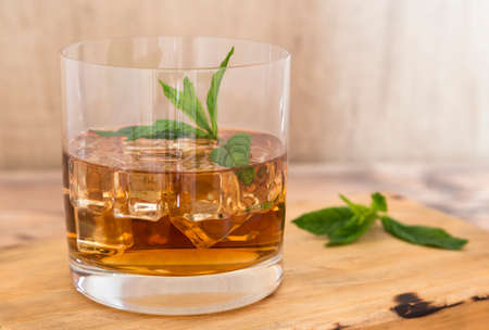 Ron glass with ice and mint. Wooden background.の写真素材