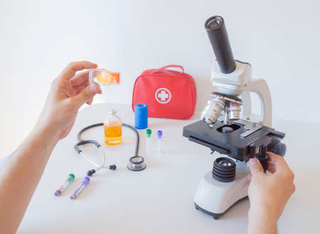 Doctor or Scientists are preparing samples to examine with a microscope in the medical laboratory....