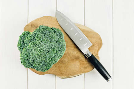 Stock photography of fresh broccoli head prepared to cut with knife. Top view.の写真素材