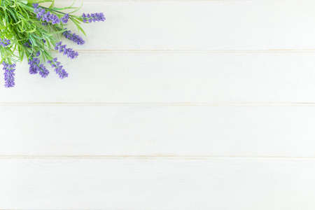 Lavender flowers arranged on white table background. Top view, flat lay mock up, copy space....