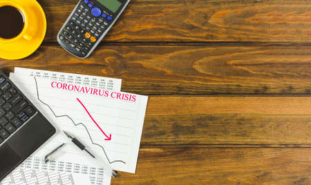 Economic Impact Of Covid 19. Text With chart, Keyboard, Calculator and plant on wooden background. Space for text.の写真素材