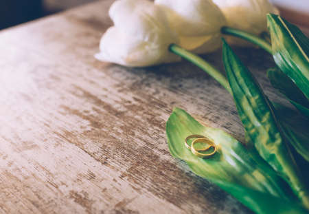 Vintage Wedding background with gold Rings and beautiful white tulips