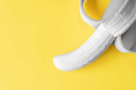 Peeled Banana on black and white on Yellow background Isolated. Copy space. Design. mockup. Top view. Healthy concept.の写真素材
