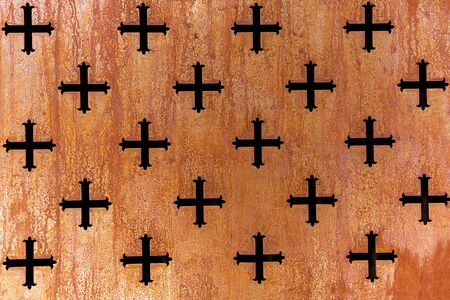 Rust metal perforation of a cross patternの写真素材