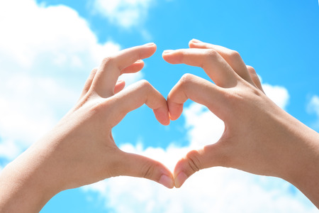 Love shape hand In Skyの写真素材