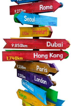 Wooden signpost indicating directions of nine world continents over white backgroundの写真素材