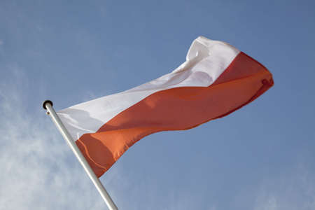 Polish Flag against Blue Backgroundの写真素材