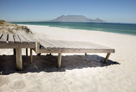 Boardwalk onto beach at Bloubergstrand beach, CApe Town, South Africa.の写真素材