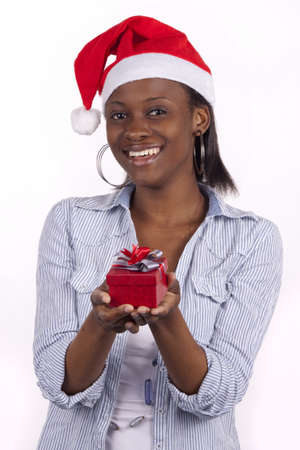 Young South African woman wearing a Santa hat and holding a present. の写真素材
