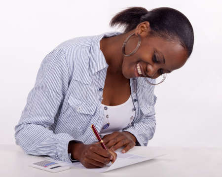 Gorgeous young South AFrican woman filling in a form.の写真素材