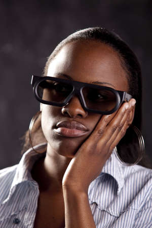 Gorgeous young woman watching a 3D movie, with 3D glasses on.の写真素材