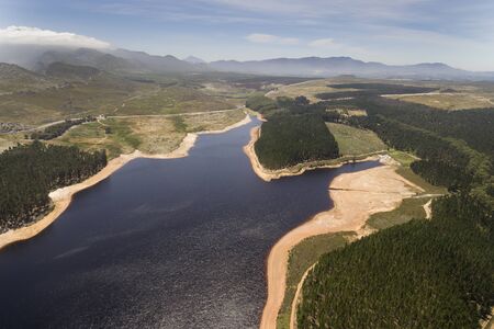 Cape Town, Jan 21 2019: The Steenbras Dam, one of the main water supply dams to Cape Town, at very low levels. This dam was a hugely important strategic asset in the Day Zero crisis in 2018 where Cape Town ran the rist of running out of water due to drought.の写真素材