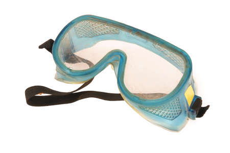 Dirty safety goggles on a white background, as used on construction sites.の写真素材