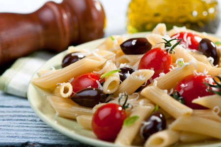 Pasta with fresh tomatoes and olives  の写真素材