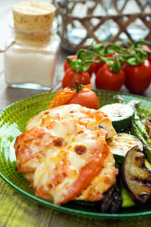Chicken with mozzarella tomato and vegetableの写真素材