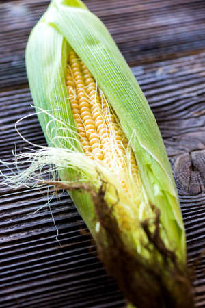 Fresh sweet corn on wooden backgroundの写真素材