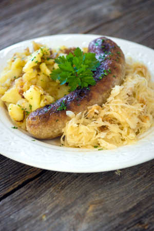 Roasted sausages with sauerkraut and potatoesの写真素材