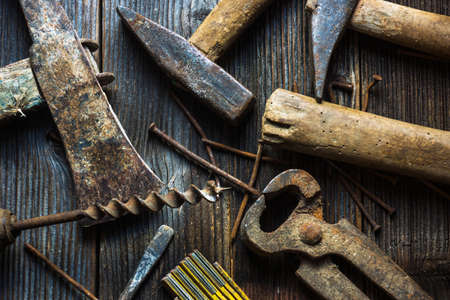 Dirty set of hand tools on wooden background