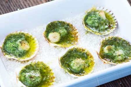 Baked  scallops with herb butterの写真素材