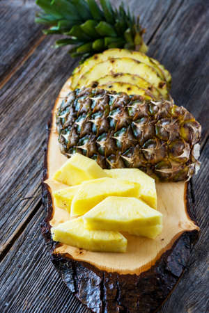 Pineapple fruit cut on wooden backgroundの写真素材