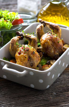 Roasted quail with vegetable on wooden backgroundの写真素材