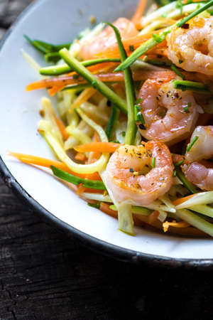 Fried shrimps with julienne vegetablesの写真素材