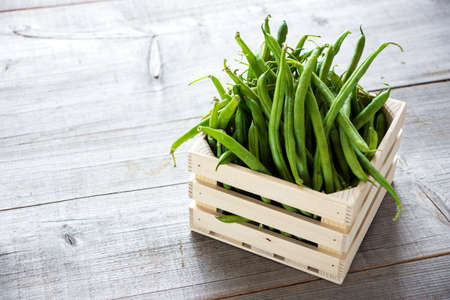 Green beans on wooden backgroundの写真素材