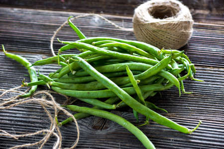 Green beans on wooden background