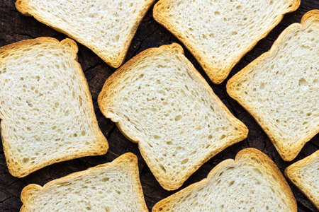 Slices of toast bread on wooden background