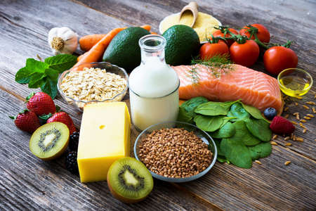 Selection of healthy food on rustic wood background